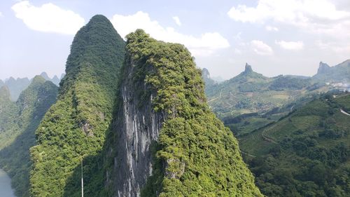 Panoramic view of trees and mountains against sky