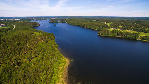 High angle view of river amidst field against sky