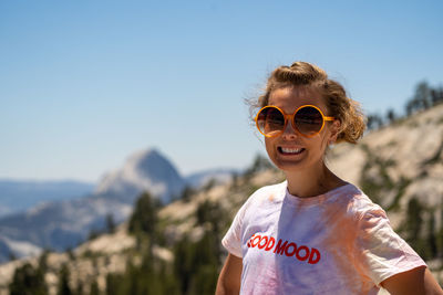 Portrait of smiling man wearing sunglasses against sky