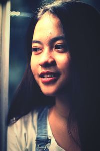 Close-up portrait of smiling young woman