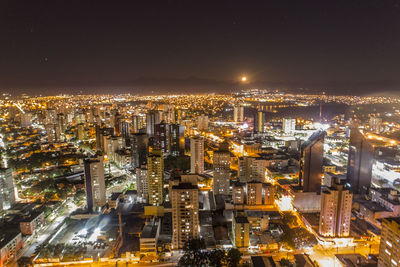 High angle view of illuminated buildings in city at night