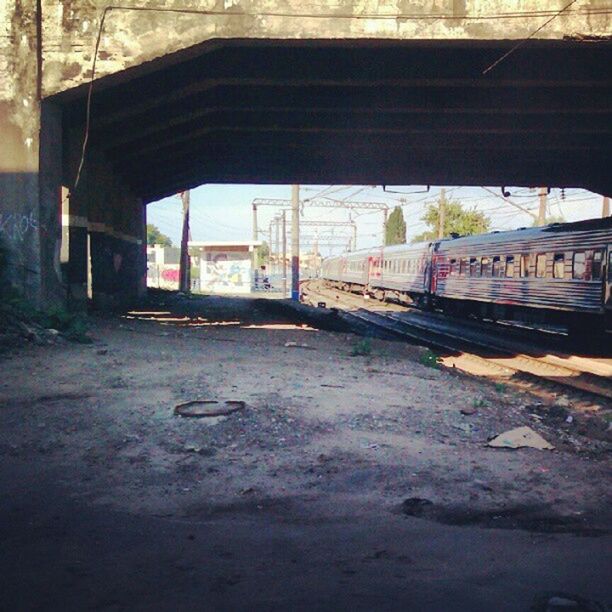 transportation, built structure, mode of transport, architecture, land vehicle, street, railroad track, indoors, car, public transportation, road, empty, building exterior, railroad station platform, rail transportation, window, no people, the way forward, day, sunlight