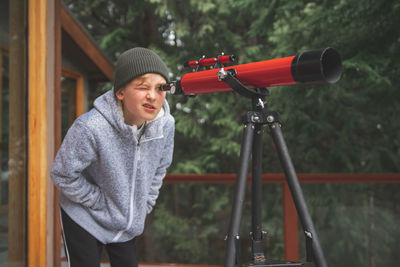 Boy looking through telescope