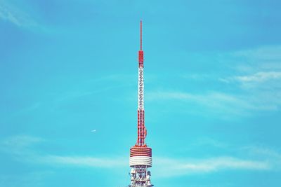 Low angle view of communications tower against sky