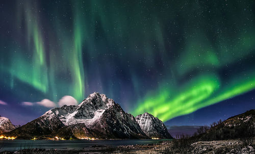 Scenic view of lake against sky at night