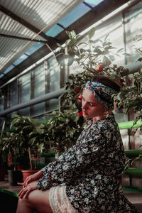 Side view of woman with potted plants