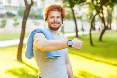 Portrait of smiling man standing in park