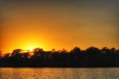 Scenic view of silhouette trees against sky during sunset