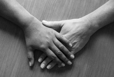 Cropped image of friends hands over table