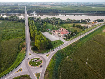High angle view of road amidst trees on field