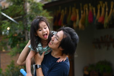 Happy man lifting daughter 