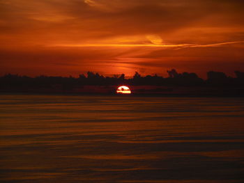 Scenic view of sea against orange sky