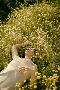 Woman lying among harestail grass ii