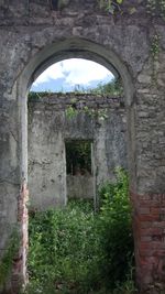 Old ruin seen through arch window