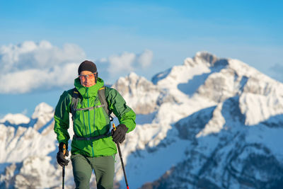 Man standing on mountain against sky