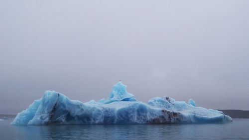 Scenic view of frozen sea against sky