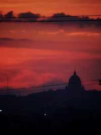 Silhouette of building against dramatic sky