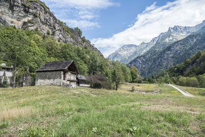 Built structure on field against mountains