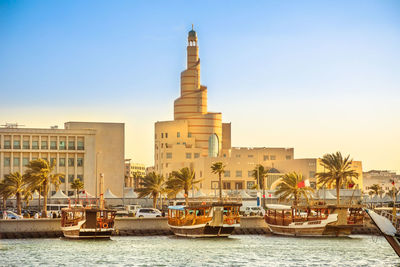 View of boats in sea against buildings