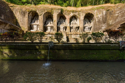 Arch bridge over river against fountain