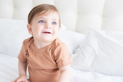 Portrait of cute baby boy sleeping on bed at home