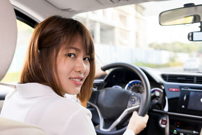 Portrait of smiling woman in car