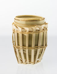 Close-up of basket on table against white background