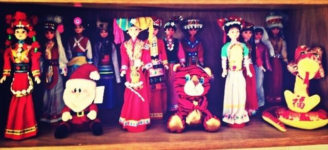 indoors, human representation, variation, red, art and craft, multi colored, cultures, retail, choice, large group of objects, creativity, in a row, celebration, tradition, arts culture and entertainment, art, for sale, illuminated