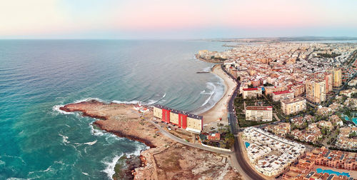 High angle view of sea and buildings against sky