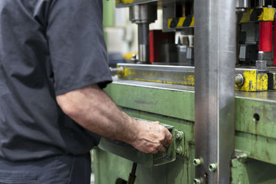 Midsection of man working in factory