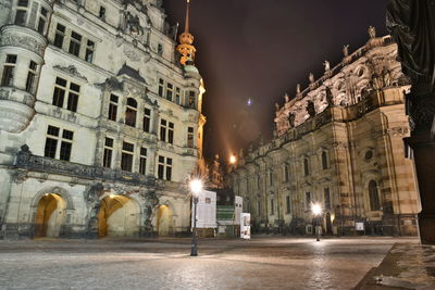 Statue in city at night