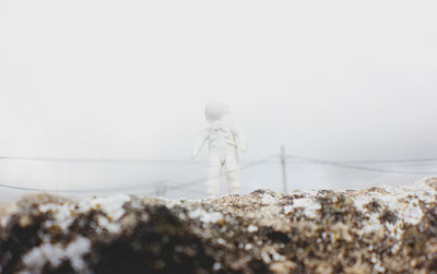 Surface level of astronaut toy on rock