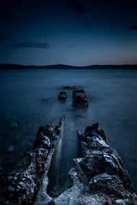 Scenic view of sea against sky at dusk