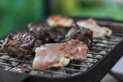 Close-up of meat on barbecue grill