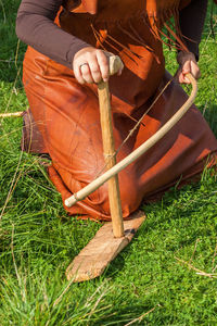 Midsection of man sitting on field