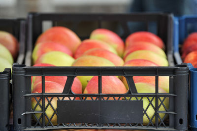 Close-up of fruits in crate at market stall apples 