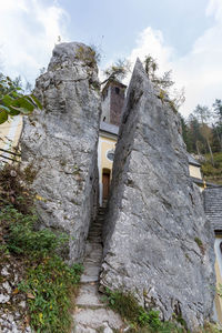 Low angle view of stone building against sky