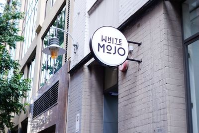 Low angle view of road sign against building