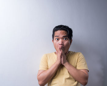 Portrait of young man against white background