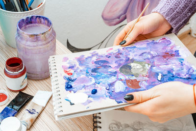 High angle view of woman hand on table