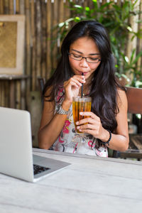 Young woman using laptop on table