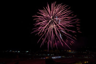 Firework display in sky at night