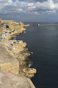 High angle view of buildings by sea against sky