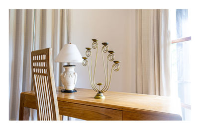 Close-up of electric lamp on table at home