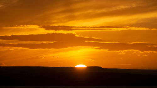 Scenic view of dramatic sky during sunset