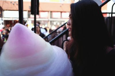 Close-up portrait of woman holding candy