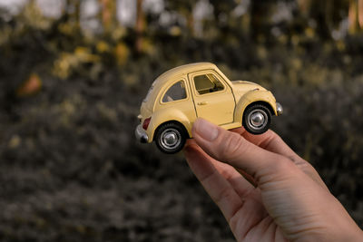 Close-up of hand holding toy car