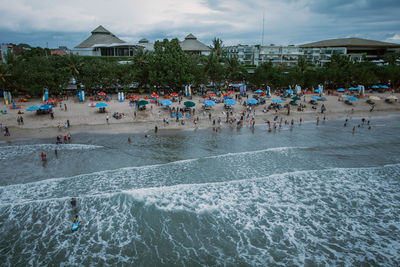 Group of people in swimming pool against sea