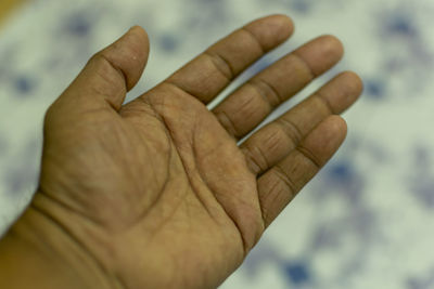 Close-up of hand holding cigarette