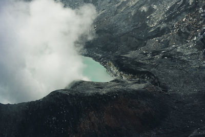 Close-up of volcanic mountain against sky